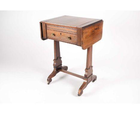 A Regency figured rosewood two flap compendium gaming table. The top with a sliding central section with parquet chess board 