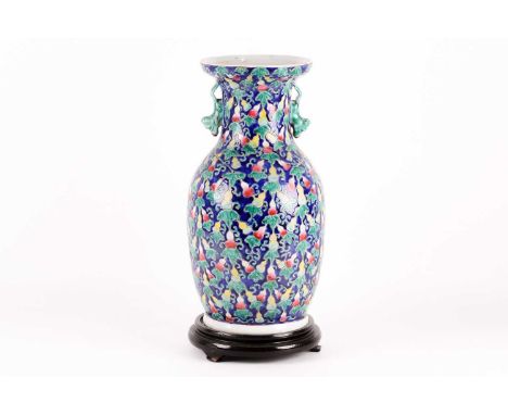 A Chinese porcelain vase, early 20th century, with applied shi shi handles, painted with red &amp; yellow double gourds on vi