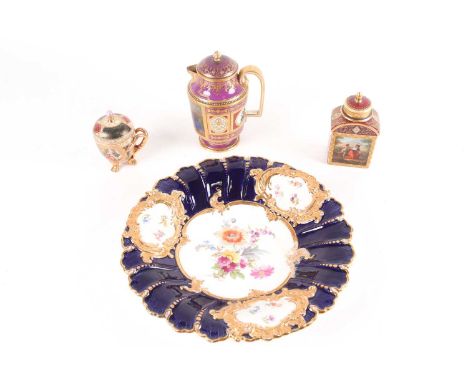 A Meissen dish with hand-painted floral decoration on an ivory ground, within cobalt blue bands and gilt finish, 29 cm diamet