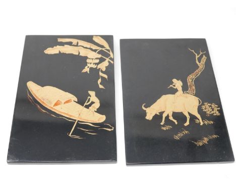 Two Chinese lacquered panels, gilt painted with man on a sampan, and a boy playing a flute on a water buffalo, each 25 x 16cm