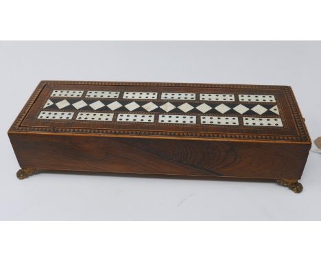 A late 19th century rosewood and parquetry inlaid cribbage box, on ormolu claw feet, together with cards, pegs and dice, H.6 