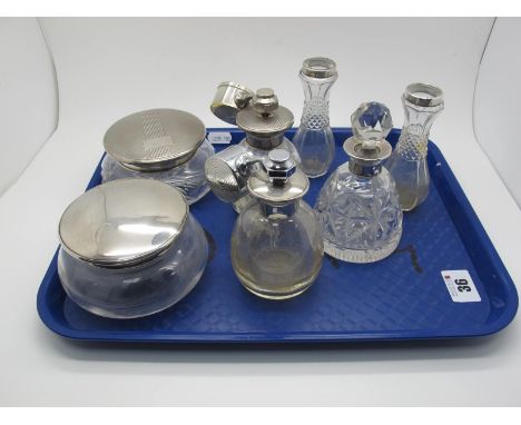 Two Hallmarked Silver Lidded Glass Powder Bowls, one with engine turned decoration; together with two perfume bottles, a pair