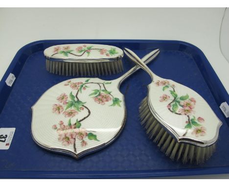 A Vintage Adie Bros Enamel Backed Three Piece Dressing Table Set, detailed with flowering pink blossom, on a white ground. (3