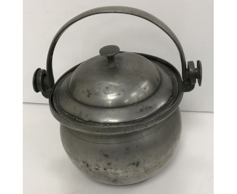 A pewter lidded tankard with scrollwork thumb piece and handle, the lid with fleur de lys decoration and stamped with crowned