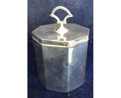 An Edwardian silver tea caddy of faceted octagonal form with swing loop handle to the lid (by William Aitken, Birmingham 1905