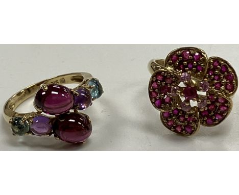 A 9 carat gold and pink sapphire set flower head design dress ring size K, 3.4 g together with a 9 carat gold and cabouchon c