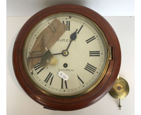 A circa 1900 mahogany cased wall dial clock, the circular enamelled dial with Roman numerals to the chapter ring enclosing th