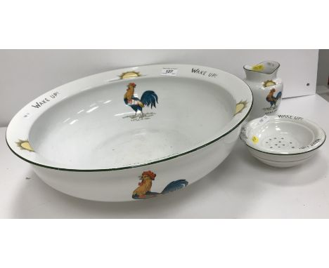 A "Chanticler" pattern toilet bowl with toothbrush holder and soap dish decorated with a crowing cockerel, inscribed "Wake up