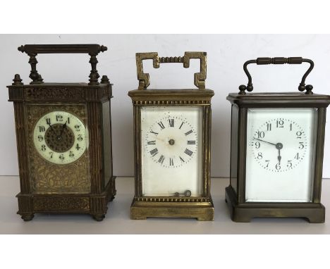 A circa 1900 French lacquered brass cased carriage clock with pierced filigree style decoration and stop fluted columns to th