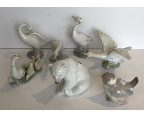 A collection of seven Lladro figures including seating polar bear, wren, goose and goslings and four further goose figures