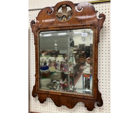 An 18th Century walnut veneered fretwork carved wall mirror with foliate gilt carved medallion surmount, inscribed on paper l