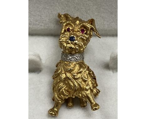 An 18 carat gold Scottie dog with diamond encrusted collar, sapphire nose and ruby eyes 3.2 cm long, 9.9 g