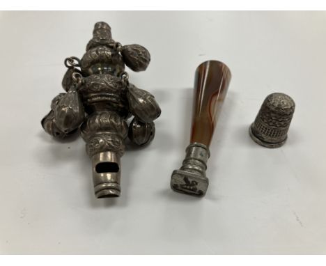 A Victorian silver baby's rattle, a Victorian silver thimble 1.895 oz and a Victorian tapering agate handled seal