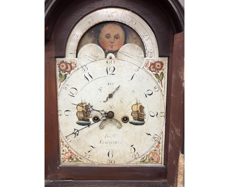 An early 19th Century mahogany cased long case clock, the eight day movement with enamelled arched dial and sun and moon phas