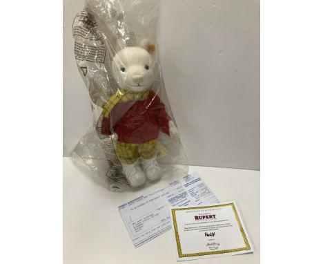 A Steiff by Danbury Mint Rupert Bear soft toy in yellow check trousers and matching scarf with red knitted jumper and leather