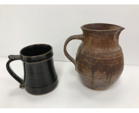 A Bernard Leach St. Ives pottery mug with scrollwork decorated handle bearing impressed mark and "England" to base 12.5 cm hi