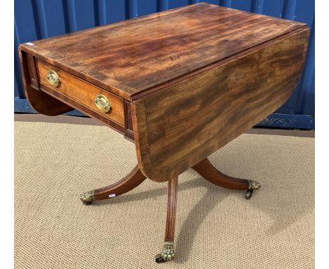 A late Regency mahogany Pembroke table, the cross-banded drop-leaf top with two end drawers, raised on a turned and ringed pe