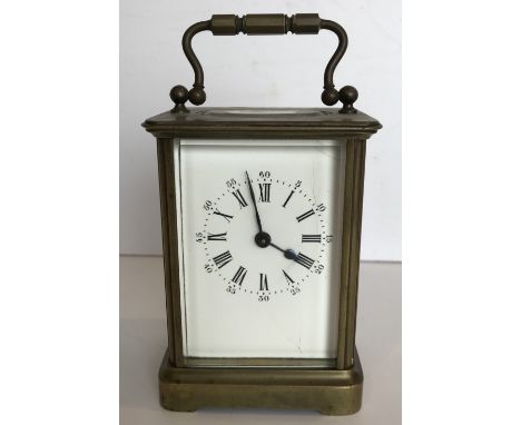 A circa 1900 French brass cased carriage clock, the white enamel dial with Roman and Arabic numerals to the chapter ring on a