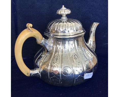 A Victorian silver teapot of embossed and engraved squash form, with scrollwork decorated ivory handle (by R & S Garrard & Co