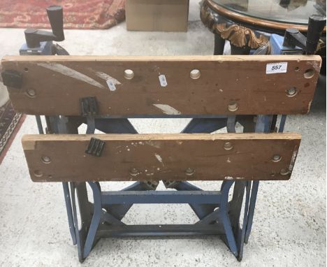 A work bench together with three tool boxes containing various tools 