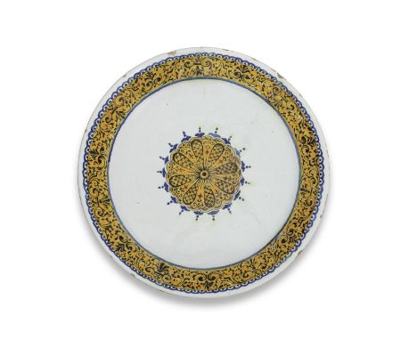 A Rouen faience plate, circa 1725Painted in ocre niellé technique with ochre borders picked out with elaborate baroque scroll