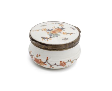 A silver-gilt-mounted Chantilly circular snuff box, circa 1740-50Painted in Kakiemon style, the cover with a flowering branch