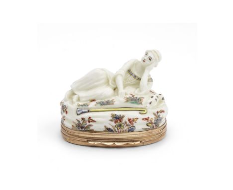 A Saint-Cloud gold-mounted figural snuff box, circa 1740In the form of a reclining shepherdess, a crook in front of her and a