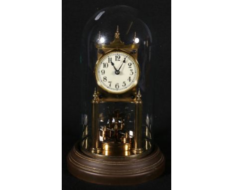 Gustav Becker brass anniversary clock, with glass dome and stand, 28cm.