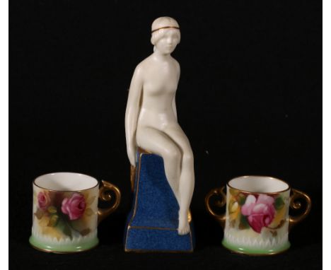 Royal Worcester figure of a seated nude female, 14cm and a pair of miniature loving cups, painted with roses by Spilsbury, 4c