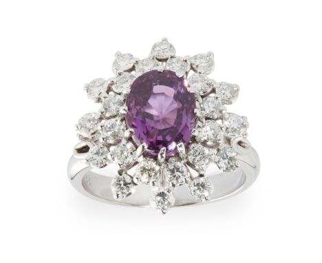 claw set with an oval-cut pink sapphire in a double border of round brilliant-cut diamonds, to a plain shank, unmarked; with 