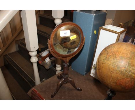 A 19th Century mahogany shaving mirror raised on tripod base AF