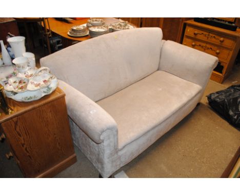 An upholstered two seater sofa with drop arm
