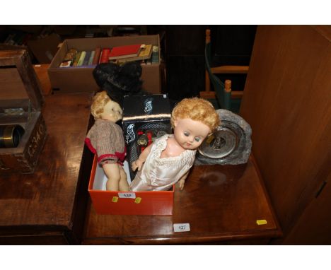 A barometer and a box of vintage dolls, dog and a Hot Wheels model