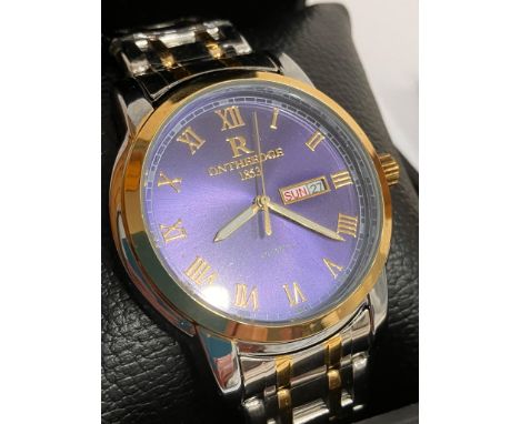 Gentlemans ON THE EDGE Quartz Wristwatch. Day/date model, having royal blue face with golden Roman numerals. Finished in stai