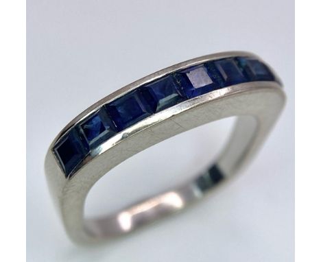 A 18K WHITE GOLD DIAMOND SAPPHIRE BAND RING. TOTAL WEIGHT 5.6G. SIZE K 