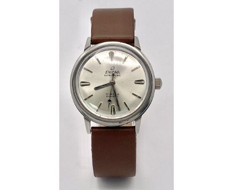 A Vintage Enicar Mechanical Gents Watch. Brown leather strap. Stainless steel case - 34mm. Silver tone dial. In working order