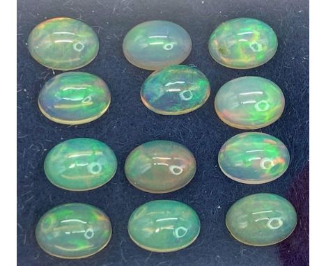 An eclectic collection of a dozen, top quality, Australian OPAL, oval cabochons with excellent iridescent hues.Dimensions: 8 