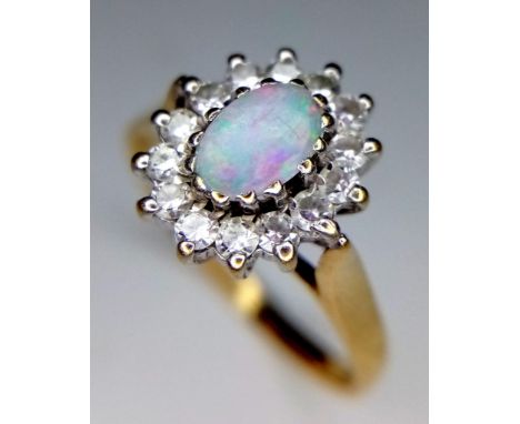 9K YELLOW GOLD OPAL AND CZ RING - 5MMX6MM OPAL CENTRE WITH HALO OF CZ STONE SETTING - 2.4G TOTAL WEIGHT - SIZE R 