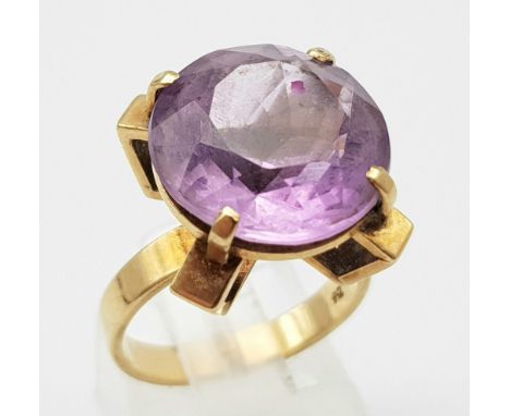 A Vintage 9K Yellow Gold Amethyst Ring. 10ct round cut amethyst set in a raised foundation. Size K. 6.1g total weight. 