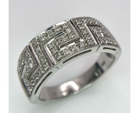 A 18K WHITE GOLD DIAMOND BAND RING. TOTAL WEIGHT 7.6G. SIZE T