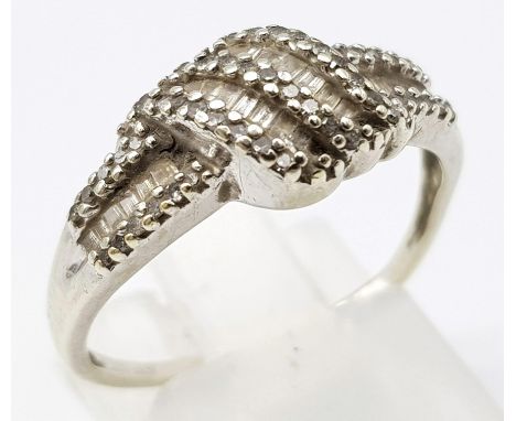 A 9K WHITE GOLD AND DIAMOND RING .   2.5gms   size O 