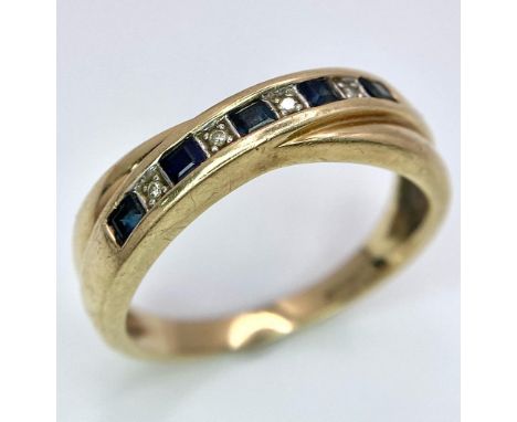 A 9K YELLOW GOLD DIAMOND &amp; SAPPHIRE CROSS OVER RING. TOTAL WEIGHT 3G. SIZE Q 