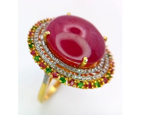 A Ruby Cabochon Ring with a Halo of Tourmalines and Diamonds on 925 Silver. Approximately 10ct ruby, 1.5ctw diamonds. Size T,