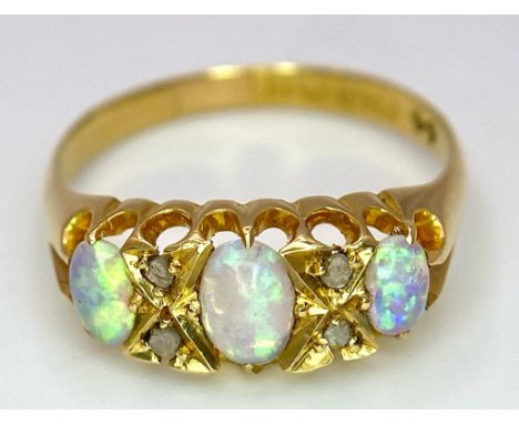A Mesmerising Antique 18K Yellow Gold, Opal and Diamond Ring. Three beautiful colour-play opals separated by four small old-c