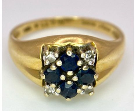 An 18K Yellow Gold Sapphire and Diamond Ring. A cross of four central sapphires with a diamond in each corner. Size N.3.95g t