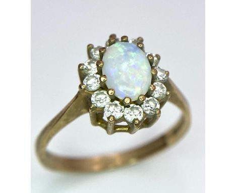 A 9K Yellow Gold, Opal and Diamond Ring. Central colour-play opal with diamond halo. Size O. 2.27g weight. 