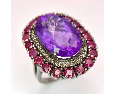 An Amethyst Ring with a Ruby and Diamond Surround on 925 Silver. 4.2ctw rubies, 0.50ctw diamonds. Size N/O, 11.32g total weig