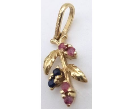 A 14K GOLD PENDANT SET WITH RUBY AND SAPPHIRE  .  1.3gms 