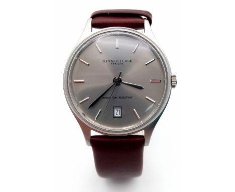A New (Ex Display) Kenneth Cole, New York Date Watch. Stainless Steel Case, Brown Leather Strap. 36mm Including Crown. Comple