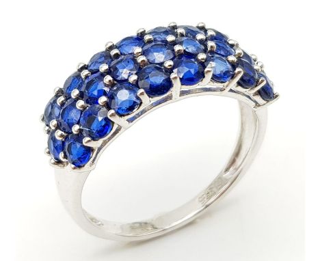 A 9K White Gold Three Row Sapphire Ring. 25 small round cut sapphires. Size R. 3.7g total weight.